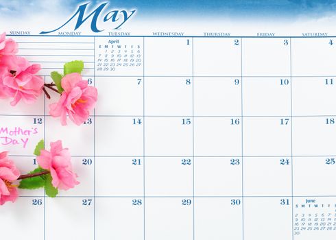 Mothers Day holiday marked on calendar with cherry blossoms  