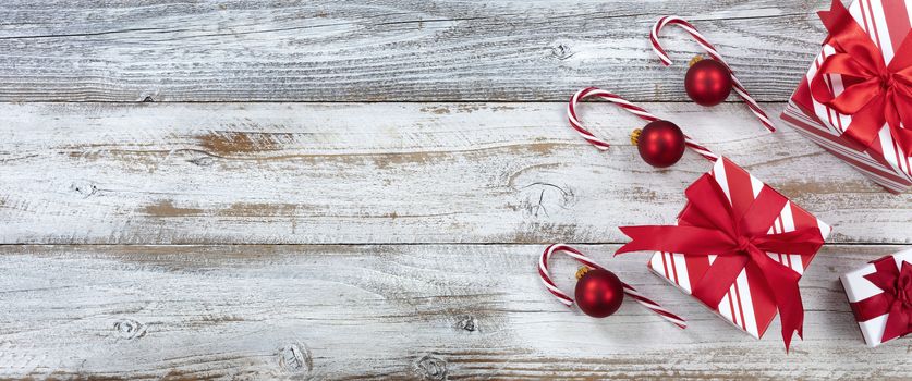 Merry Christmas with gifts and ornaments on white weathered wooden background for the holiday