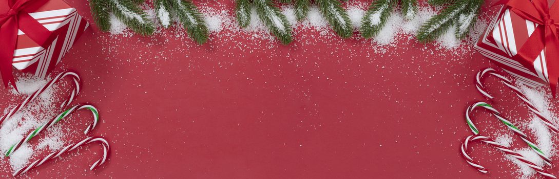 Seasonal Christmas decorations on red background with snow  
