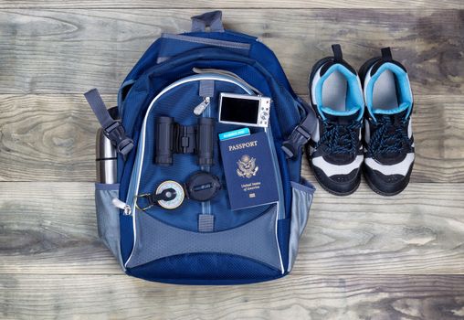 Top view shot of travel gear on aged wooden boards