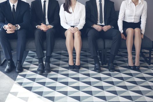 Stressful people waiting for job interview sitting in a row