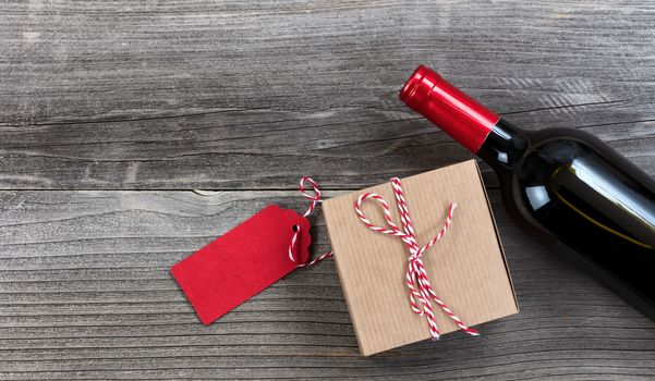 Fathers day gift box with red wine bottle on vintage wooden plank background