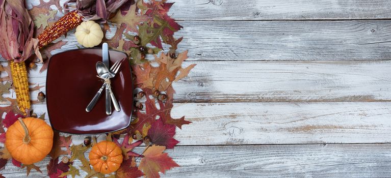 Autumn Traditional Thanksgiving holiday dinner table setting on rustic table with decorations