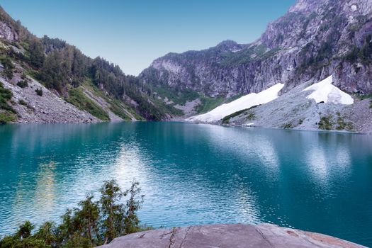 Glacier lake with mountains and snow during summer season 