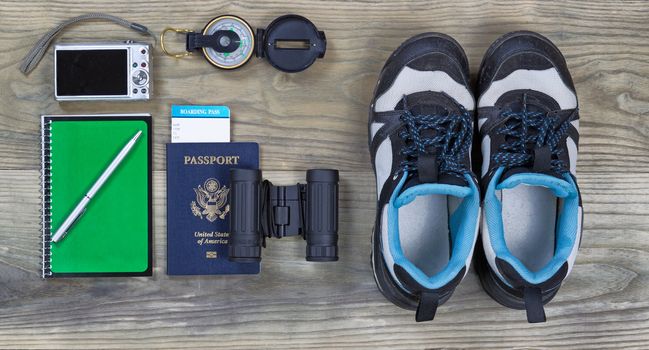 Travel gear basics on aged wooden surface