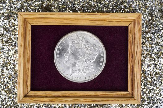 Fine Silver Dollar in Jewelry box with glitter in background