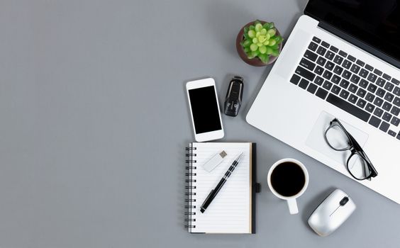 Overhead view of mobile functional gray desktop with copy space 