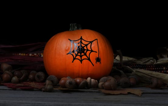 Decorated pumpkin for Halloween holiday with dark background setting