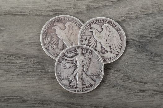 Old silver half dollars on aging wood background