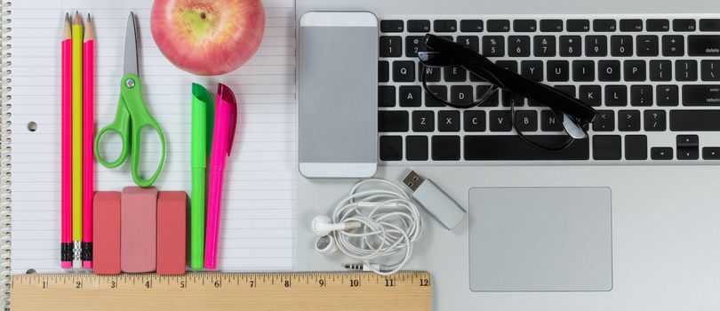 Back to School evolution with traditional supply items merging into modern technology 