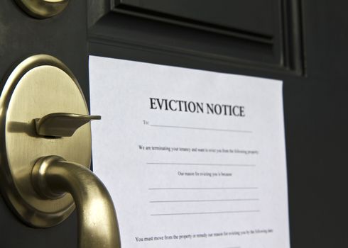Eviction notice letter posted on front door of house