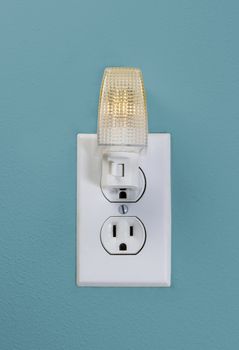 Small White LED Wall Light plugged into electrical wall outlet 