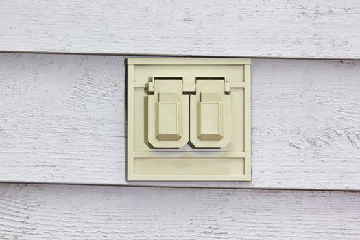 Outdoor electrical outlet on wood sliding