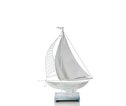 Sailboat made of metal isolated on a pure white background with reflection