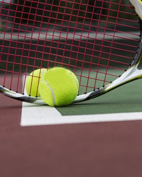 Two Tennis Balls and Racket on Outdoor Court 