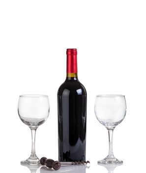Red wine bottle and drinking glasses isolated on white with reflection
