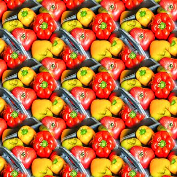 Abstract seamless background with bright red and yellow peppers on a gray wooden tray