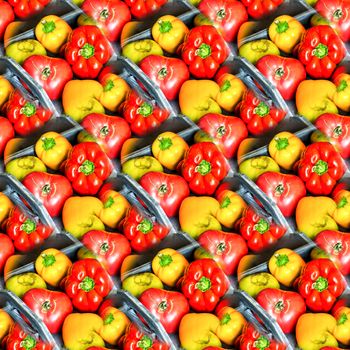 Abstract seamless background with bright red and yellow peppers on a gray wooden tray