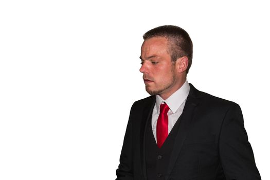 Young man in suit with red tie against white background, copy space.