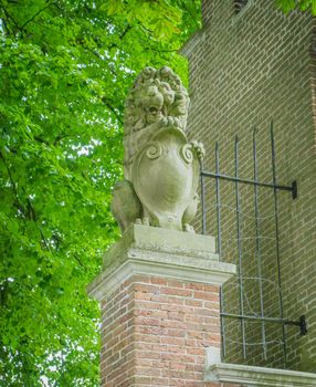 stone lion statue on a brick pole