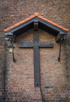 old medieval style christian cross under a shed