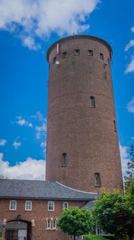 water tower made of bricks with side building and gate