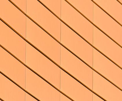 architectural abstract pattern fragment of a wall of a yellow modern building on a blue background