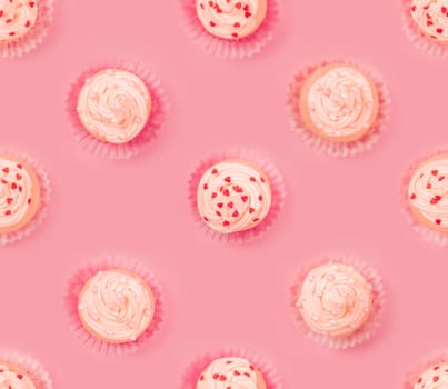 Valentine day love cupcake decorated with cream and hearts on pink background seamless tile food pattern