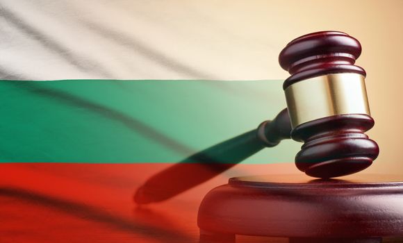 Lawyers wooden gavel resting on its plinth over the flag of Bulgaria in a concept of the courts, legality and law and order