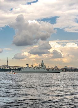 Istambul, Turkey – 07.12.2019. Passage of a warship through the Bosphorus Strait on a summer evening