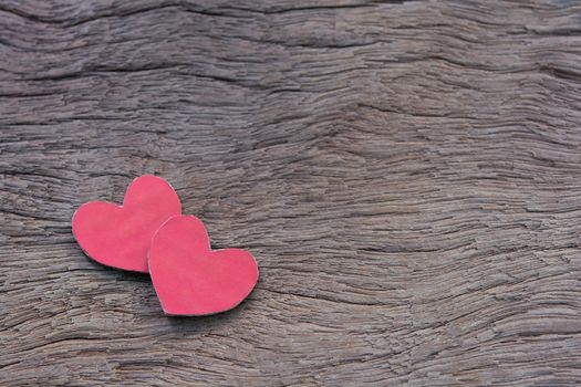 Valentines Day background with red heart shape on dark wooden background with copy space
