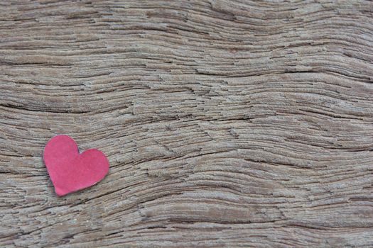 Valentines Day background with red heart shape on dark wooden background with copy space
