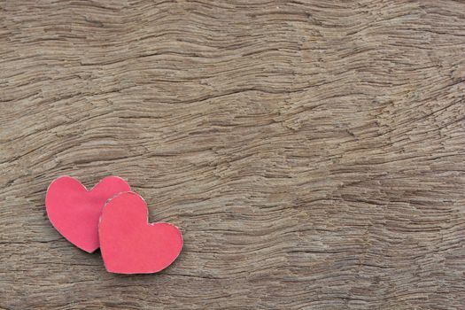 Valentines Day background with red heart shape on dark wooden background with copy space
