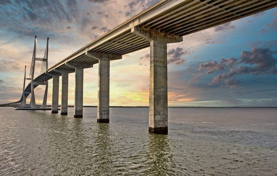 A long span of bridge over the water on a grey winter day