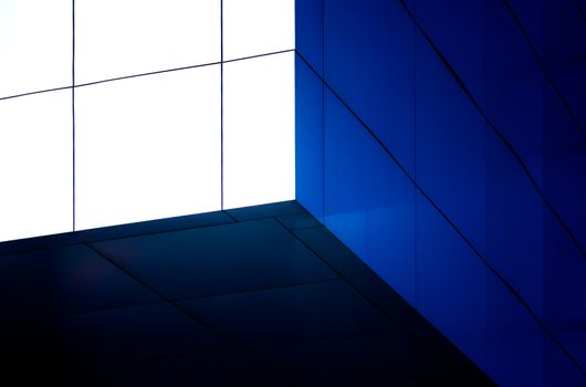 architectural abstract pattern fragment of a wall of blue modern building on a white background