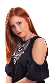 Head shot of a beautiful, attractive redheaded young woman with clean make up, stylish black blouse and modern silver necklace, isolated on white background. Fashion and beauty concept.