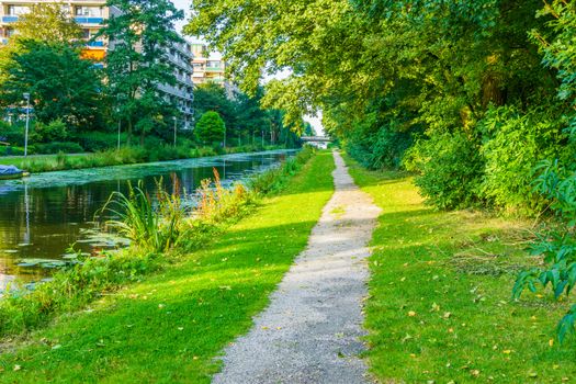 long walking path in beautiful water lake park landscape