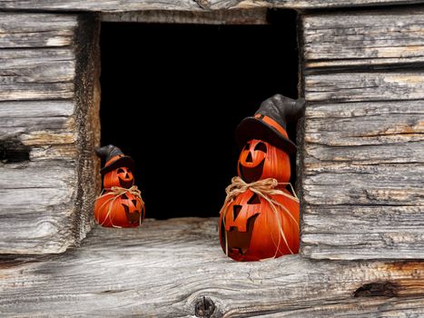 Halloween window frame with pumpkins wearing a witch hat