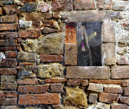 Halloween scary Witch and ghost forest with cabin through a window of a brick stone wall covered in spider web rags