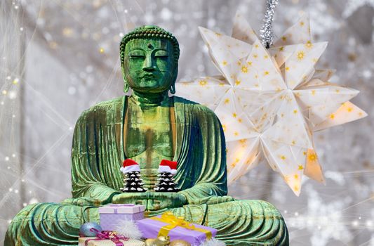 Christmas card buddha monk statue holding 2 christmas trees with hats and star background