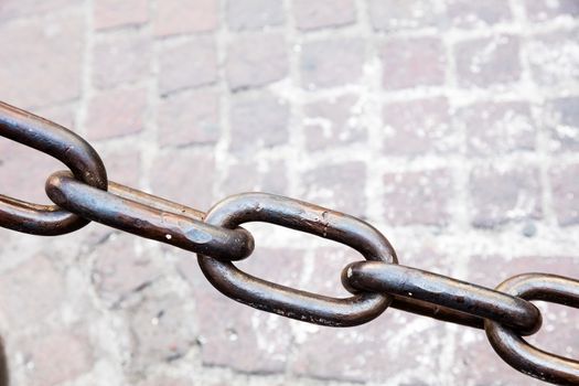 Metal chain as the fence on street