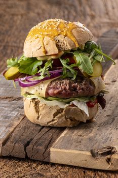 home made cheeseburger on dark wood