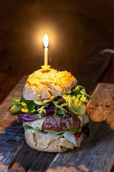 home made cheeseburger on dark wood