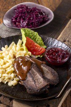 closeup of a german sauerbraten with dumplings