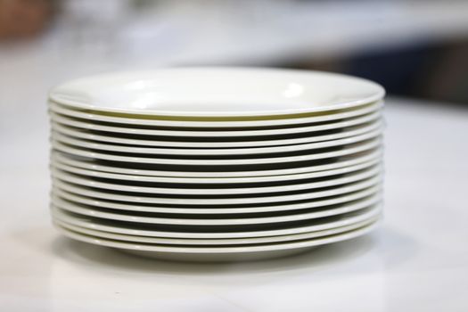 A stack of white plates.Plenty of plates. Plates from the restaurant. White plates. Plates for food