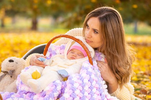 Mom relaxes with newborn baby in park