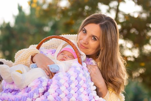 Mom hugs baby sleeping in basket