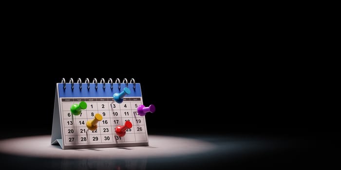 Colorful Thumbtack on a Blue and White Desk Calendar Spotlighted on Black Background with Copy Space 3D Illustration