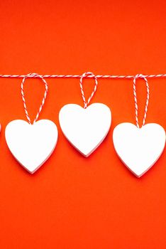 Valentine's Day Background.Valentines day concept. Greeting card. Copy space. Three wooden white hearts on a white background.