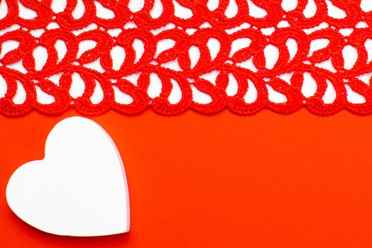 White and red wooden hearts on a red and white background. Blank for the designer. Valentines day concept. Greeting card. Valentine's Day. Copy space.